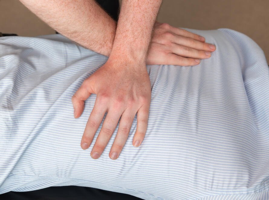 Osteopath performing gentle manual therapy on patient at Myoset Canary Wharf to relieve pain and improve mobility